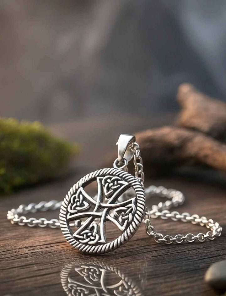 Detailansicht Keltisches Lebensrad Silberanhänger mit Kreuzsymbol und keltischen Ornamenten auf reflektierender Fläche an Silber Ankerkette.