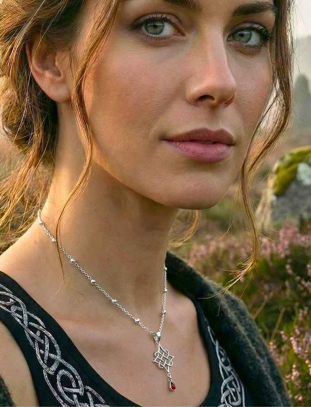 Model trägt Silberanhänger "Herz des alten Hains" mit rotem Schmuckstein an Silberkette "Schimmernde Himmelsperlen"