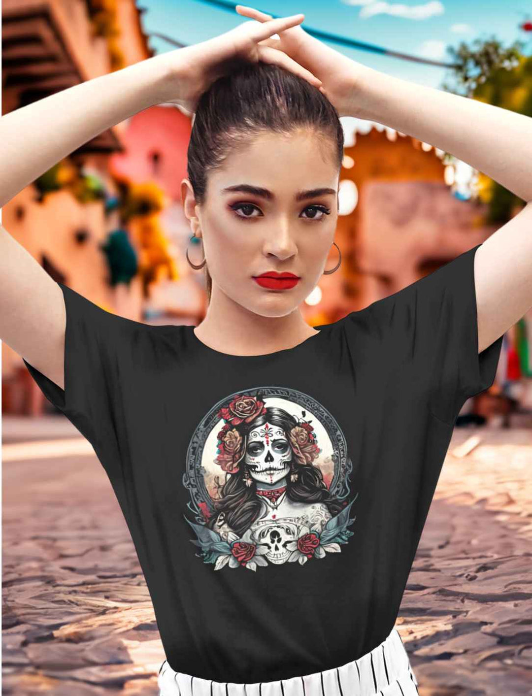 Junge Frau in Mexiko mit dem Unisex La Catrina Shirt in Schwarz, auf einer Straße während des Día de los Muertos – Runental.de