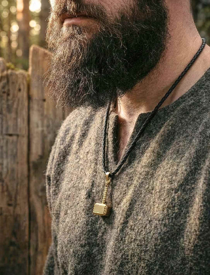 Mann trägt Mjölnir Thorhammer Anhänger als Wikinger Schmuck an Lederkette