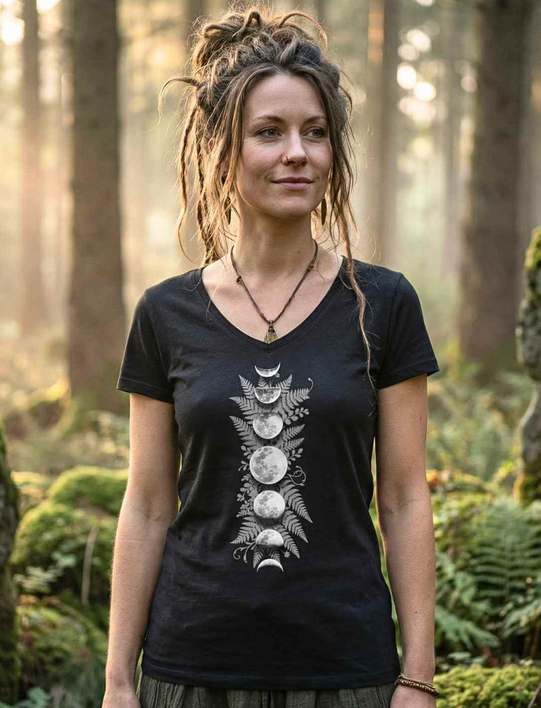 Sacred Moon – Forest Mysteries Damen V-Neck Shirt Schwarz mit Mondphasen und Farnmotiv, getragen von Frau im Wald