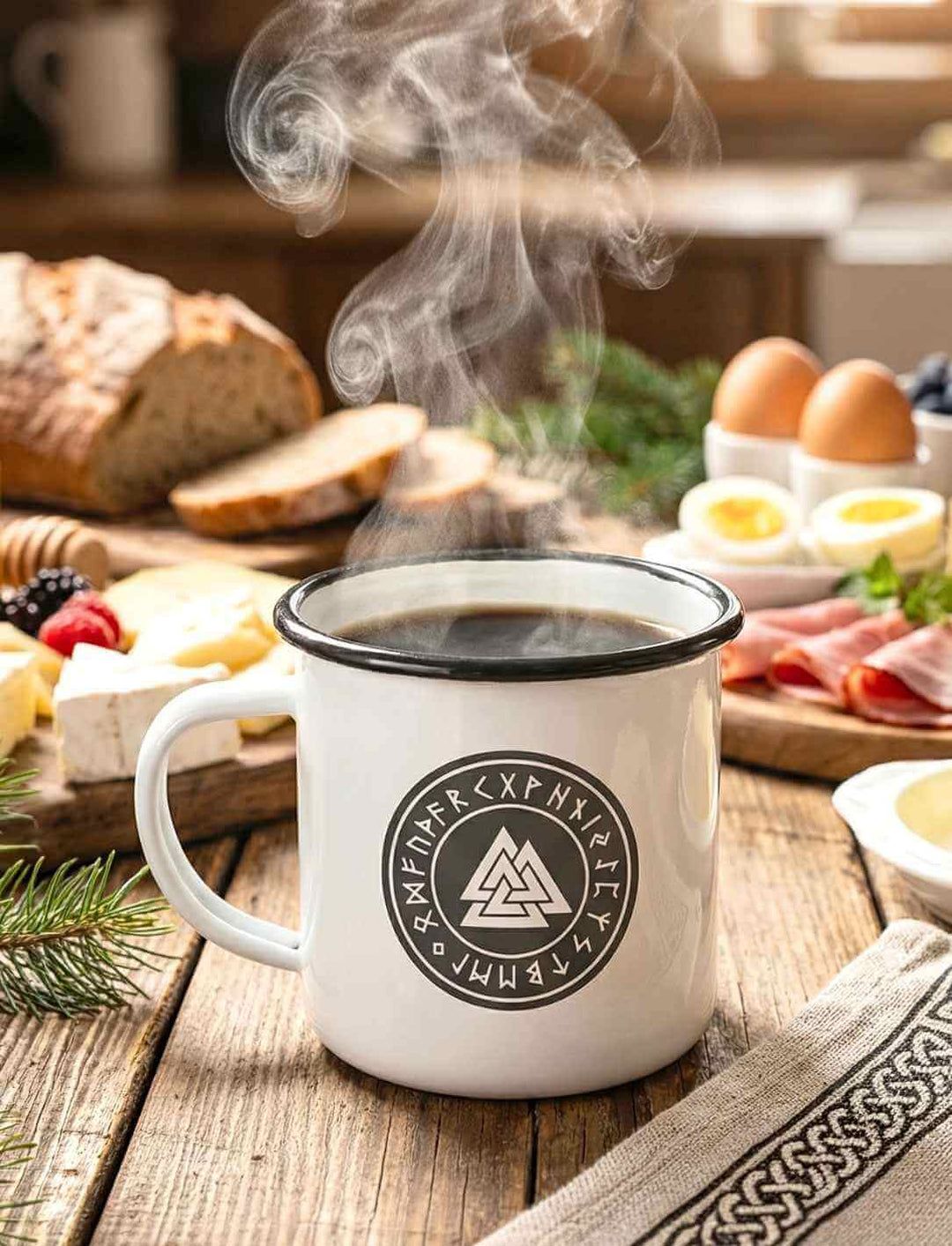 Weiße Valknut Emaille Tasse mit schwarzem Rand auf Holztisch beim Frühstück, nordisches Symbol doppelseitig bedruckt