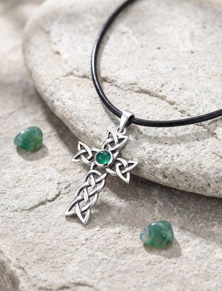 Achat Anhänger aus Silber mit keltischem Knotenkreuz am Lederband auf einem Flussstein