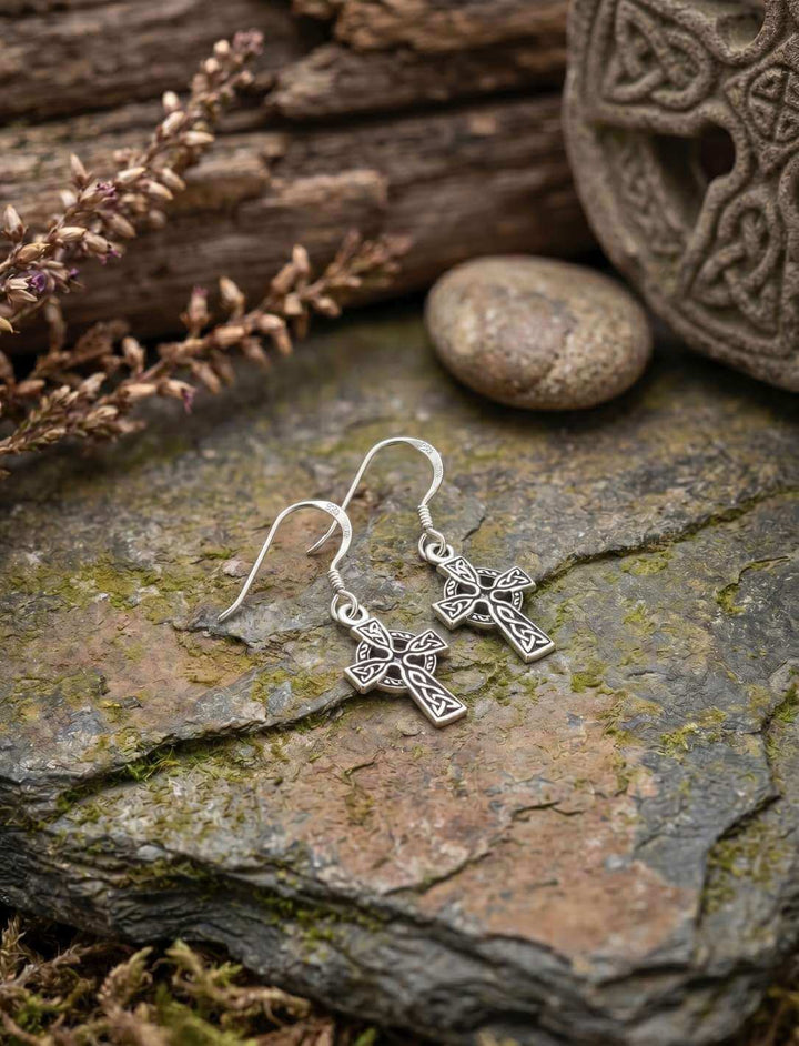Keltenkreuz Ohrhänger aus 925 Sterling Silber auf Schiefergestein vor keltischem Ornament