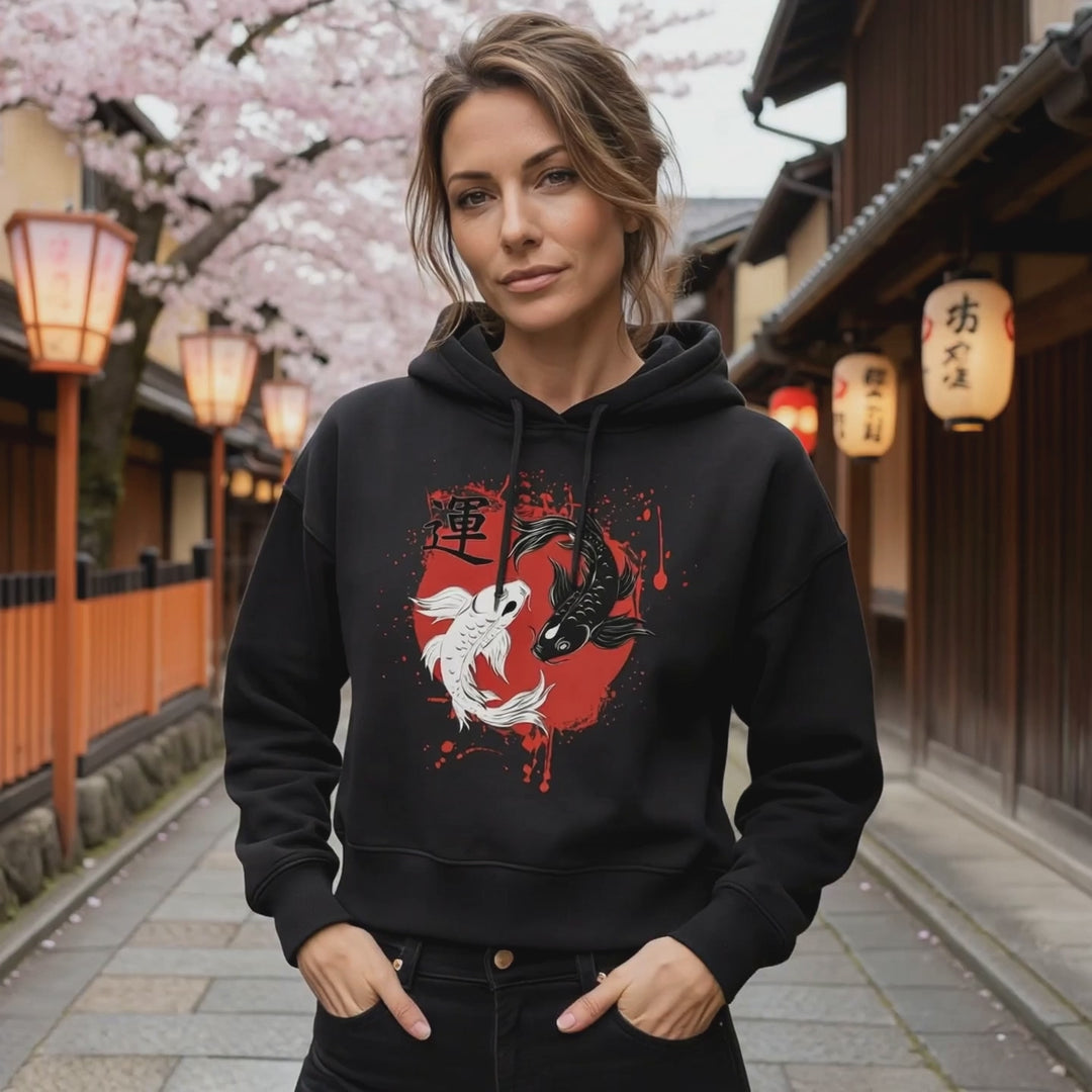 Eine Frau trägt das Harmonic Koi Boxcut Hoodie in schwarz. Video in einer japanischen Strasse.