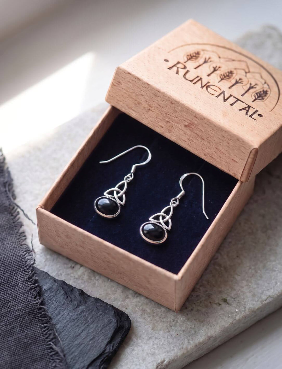 Trinity Knot Ohrringe mit Onyx in der Runental Schmuckschachtel