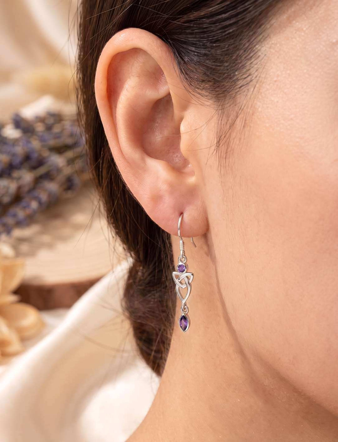 Silber Ohrhänger Triquetra mit violettem Zirkonia am Ohr getragen