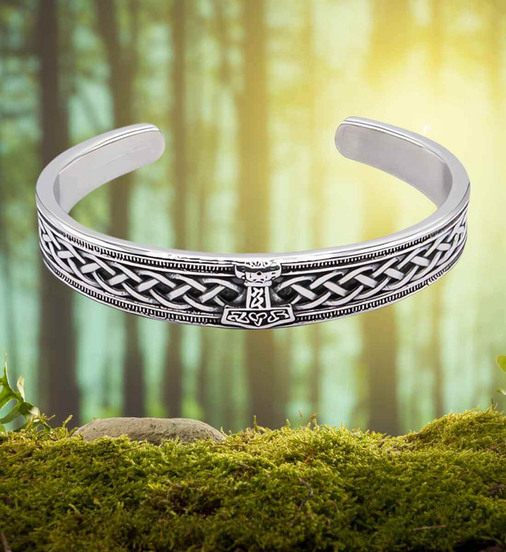 Wikinger Armreif aus Edelstahl mit Mjölnir und Knotenornamentik auf moosigem Untergrund